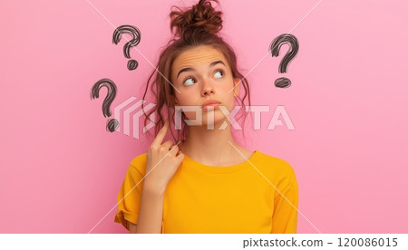 Reflective Young Woman Drawing Question Marks On A Pink Background: A Contemplative Image Capturing A Thoughtful Moment Of Introspection And Curiosity. Reflective Young Woman Drawing Question Marks On A Pink Background: A Contemplative Image Capturing A Thoughtful Moment Of Introspection And Curiosity. 120086015