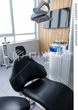 Dental equipment in empty dentist office in new modern clinic room, dental chair and accessories Dental equipment in empty dentist office in new modern clinic room, dental chair and accessories 120086509