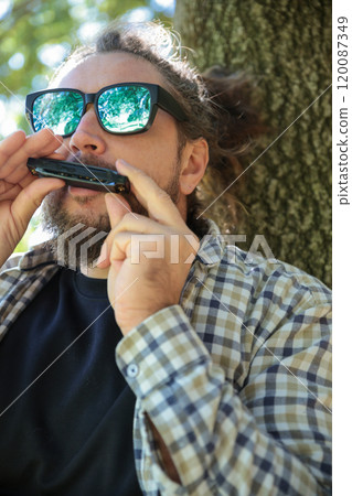 Man Wearing Sunglasses Playing Harmonica, Mouth Organ 120087349