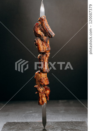 Succulent grilled meat skewer, perfect for barbecue or gourmet cuisine presentations 120087379