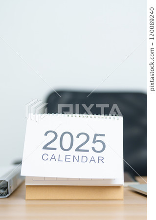 2025 Year Calendar on table with laptop computer during working and writing in office. countdown, Happy New Year, Resolution, Year End and New Start and Goals Plan Action Concept 120089240
