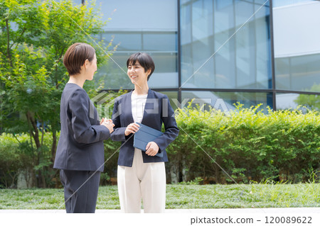 Two women smiling in front of an office 120089622