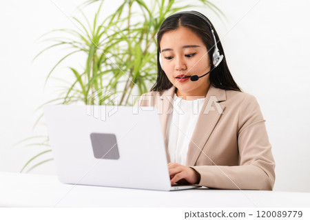 Young female operator operating a personal computer Business image 120089779