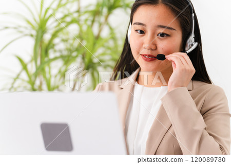 Young female operator operating a personal computer Business image 120089780