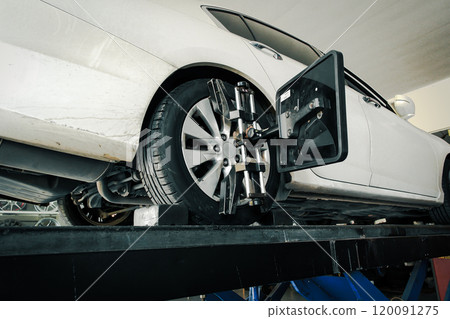 Vehicle wheel alignment with standard wheel alignment machine in auto repair shop Vehicle wheel alignment with standard wheel alignment machine in auto repair shop 120091275