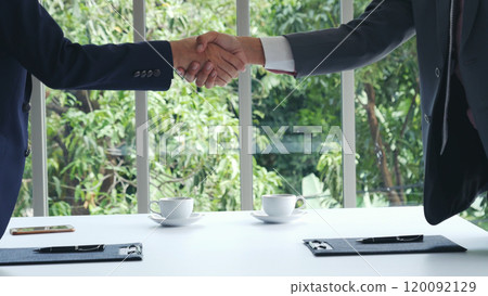 Team Business Partners shaking hands together to Greeting Start up new project. Shakehand Teamwork Partnership at office desk. Businessman partners handshake together.  Business concept 120092129