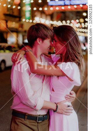 A Romantic Evening Embrace Under Glimmering City Lights Captured Beautifully in Time 120092185