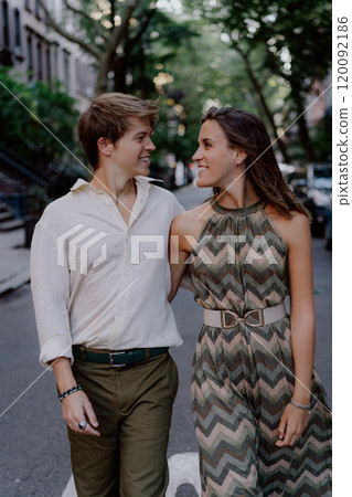 Joyful Couple Holding Hands While Walking Together in an Urban Setting, Enjoying Life 120092186
