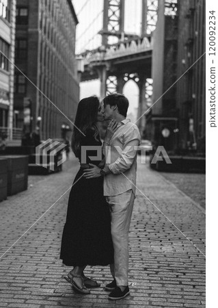 A couple passionately embracing each other in the vibrant urban landscape of the city 120092234