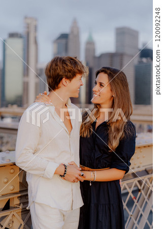 A Romantic Couple Deeply Embracing Each Other on the Beautiful Brooklyn Bridge at Dusk A Romantic Couple Deeply Embracing Each Other on the Beautiful Brooklyn Bridge at Dusk 120092248