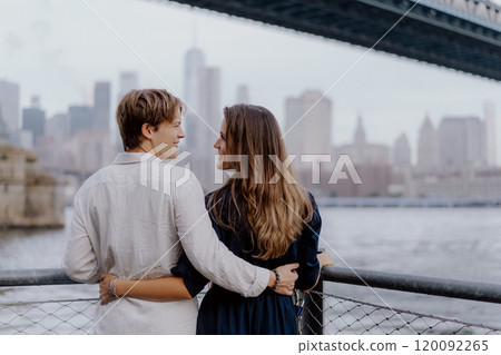 Romantic Couple Embracing in a Beautiful Cityscape by Water, Exuding Love and Joy 120092265