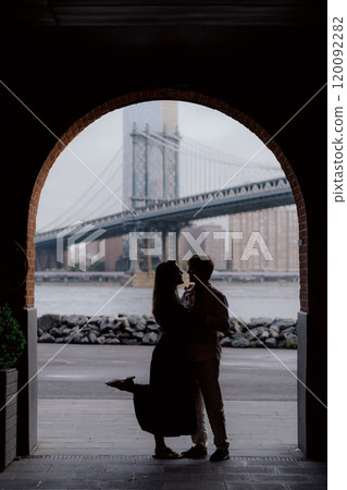 A Beautiful and Romantic Silhouette Captured Under a Bridge During the Enchanting Dusk 120092282