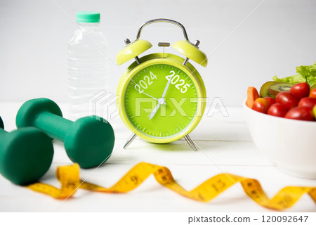 2025 and 2024 on alarm clock with workout planing for dieting. 2025 and 2024 on alarm clock with workout planing for dieting. 120092647