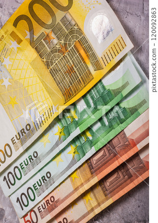 A collection of Euro banknotes in various denominations, showcasing their unique designs and differences A collection of Euro banknotes in various denominations, showcasing their unique designs and differences 120092863