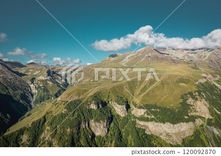 Stunning Aerial View of the Majestic Mountain Landscape, Set Beneath a Clear and Beautiful Blue Sky Stunning Aerial View of the Majestic Mountain Landscape, Set Beneath a Clear and Beautiful Blue Sky 120092870