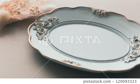 Antique plate and pink dried flowers, accessory tray, antique background Antique plate and pink dried flowers, accessory tray, antique background 120093323