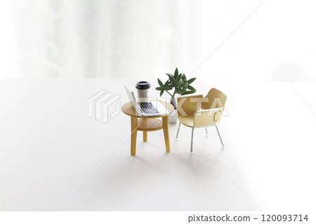 A table and chair with a miniature laptop on it A table and chair with a miniature laptop on it 120093714