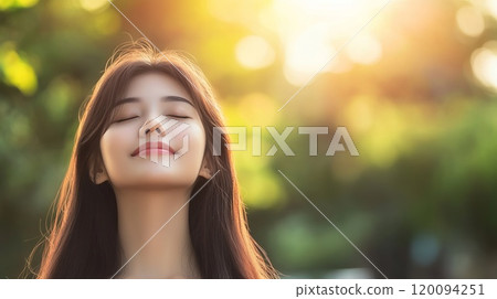 Joyful Asian Woman Embracing Nature Beauty 120094251