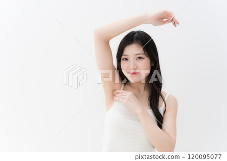 Hair removal/beauty: Young woman concerned about her armpits, upper body 120095077