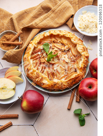 Delicious homemade apple galette with fresh apples, almond slices, and spices 120096318