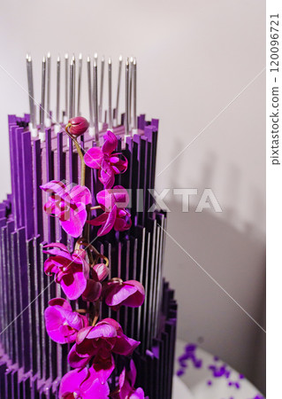 Large and beautiful purple three-tiered cake with flowers.  120096721