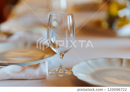 An empty wine glass on a table served for a banquet. An empty wine glass on a table served for a banquet. 120096722