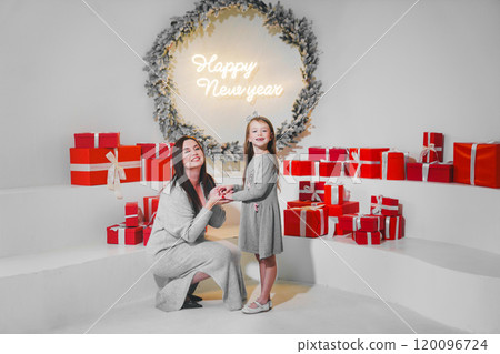 happy mom and daughter with red gift box in christmas decor. 120096724