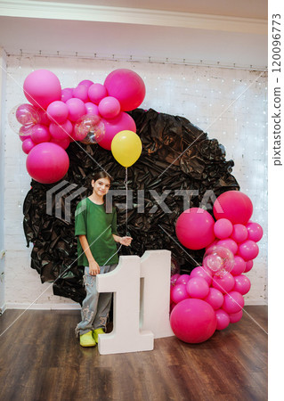 Cute teenage girl on the background of decor with the number eleven for birthday Cute teenage girl on the background of decor with the number eleven for birthday 120096773