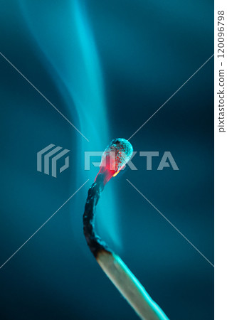 Smoke from an extinguished match on a dark turquoise background. Macro. Close-up. Match. Smoke from an extinguished match on a dark turquoise background. Macro. Close-up. Match. 120096798