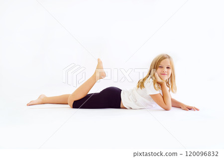 Cheerful teenage girl in white t-shirt and black breeches on white background Cheerful teenage girl in white t-shirt and black breeches on white background 120096832