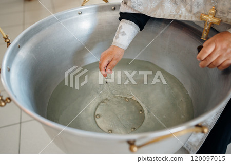 The priest performs chrismation at the sacrament of baptism. 120097015