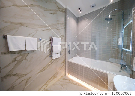 The interior of a modern bathroom is in beige tones. The interior of a modern bathroom is in beige tones. 120097065