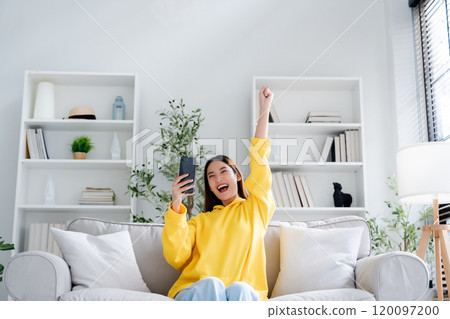 Happy young asian woman relax on comfortable couch at home Happy young asian woman relax on comfortable couch at home 120097200