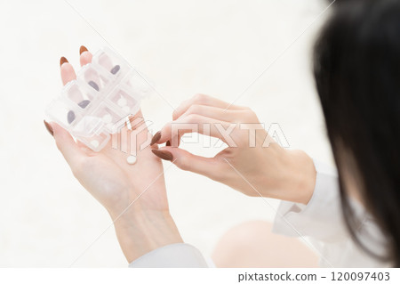 Young woman holding supplements 120097403