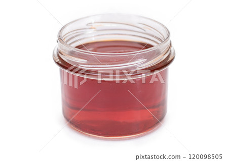Dark Honey in a Small Glass Jar Isolated 120098505