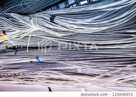bunch of network cables in wave pattern leading across server ro 120098953