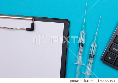 Vaccination or Revaccination Concept - Two Medical Syringe on Blue Table Vaccination or Revaccination Concept - Two Medical Syringe on Blue Table 120099494