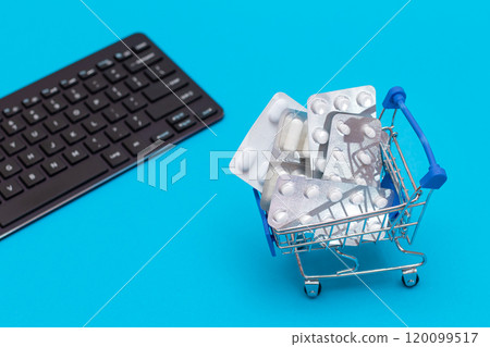 Ordering Medicines. Pills and Capsules in a Shopping Cart on Blue Background Ordering Medicines. Pills and Capsules in a Shopping Cart on Blue Background 120099517
