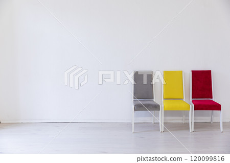 many chairs of different colors in the interior of an empty white office room 120099816