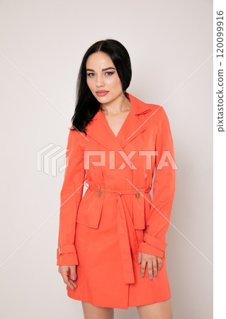 Portrait of a beautiful fashionable woman in a red autumn dress 120099916