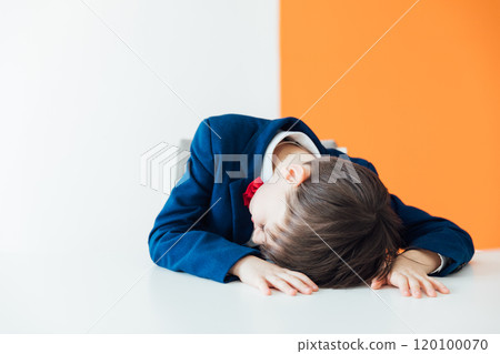 Schoolboy Boy In Business Suit Sleeping Tired At Table Schoolboy Boy In Business Suit Sleeping Tired At Table 120100070
