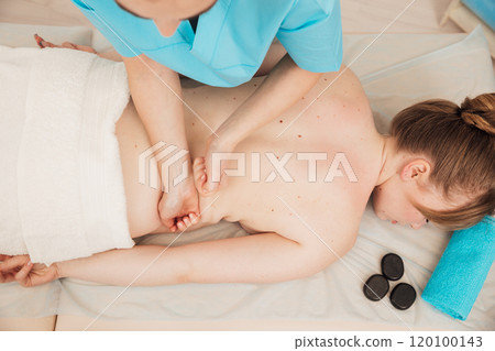 chiropractor giving medical facial massage to woman in spa 120100143