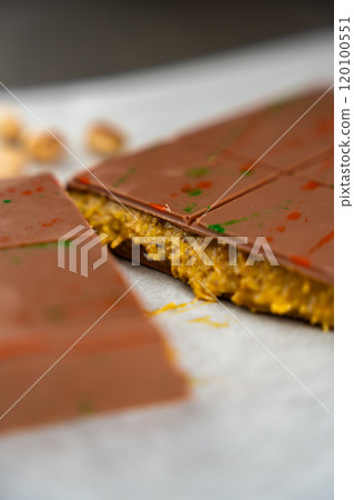 Trend Dubai chocolate with pistachio paste and kataifi dough. Confectionery handmade sweets at home in the kitchen.  120100551