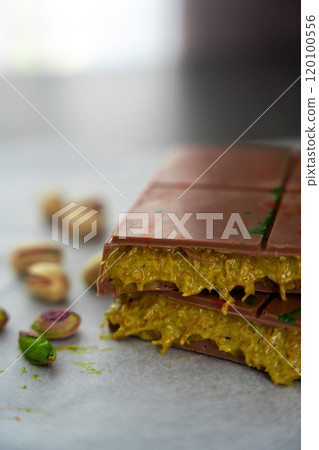 Trend Dubai chocolate with pistachio paste and kataifi dough. Confectionery handmade sweets at home in the kitchen.  120100556