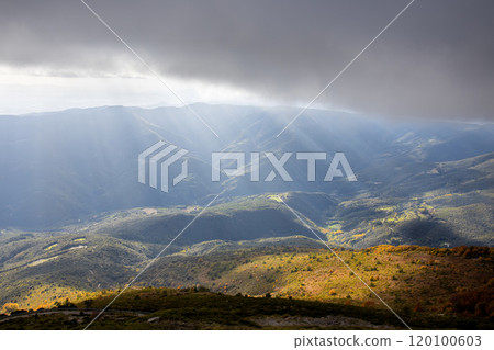 Sunset light in a Spanish Montseny Mountain in autumn time. Sunbeams light. Sunset light in a Spanish Montseny Mountain in autumn time. Sunbeams light. 120100603