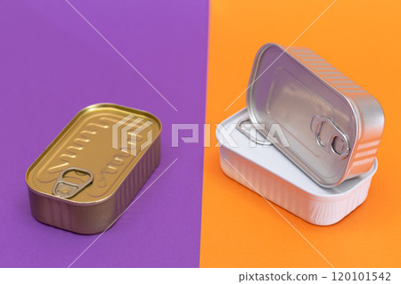 A Group of Stacked Tin Cans with Blank Edges on Split Orange and Violet Background 120101542