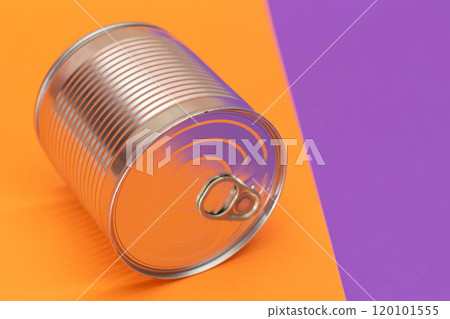 Unopened Tin Can on Split Orange and Violet Background Unopened Tin Can on Split Orange and Violet Background 120101555