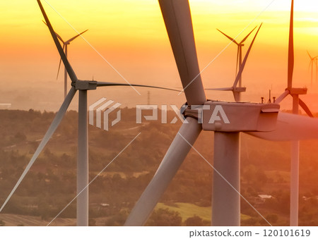 Wind farm field and sunset sky. Wind power. Sustainable, renewable energy. Wind turbines generate electricity. Sustainable development. Green technology for energy sustainability. Eco-friendly energy. 120101619