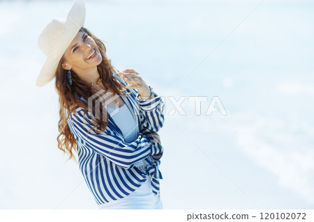 happy stylish woman on seashore with straw hat happy stylish woman on seashore with straw hat 120102072
