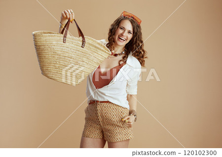 happy woman in blouse and shorts on beige 120102300